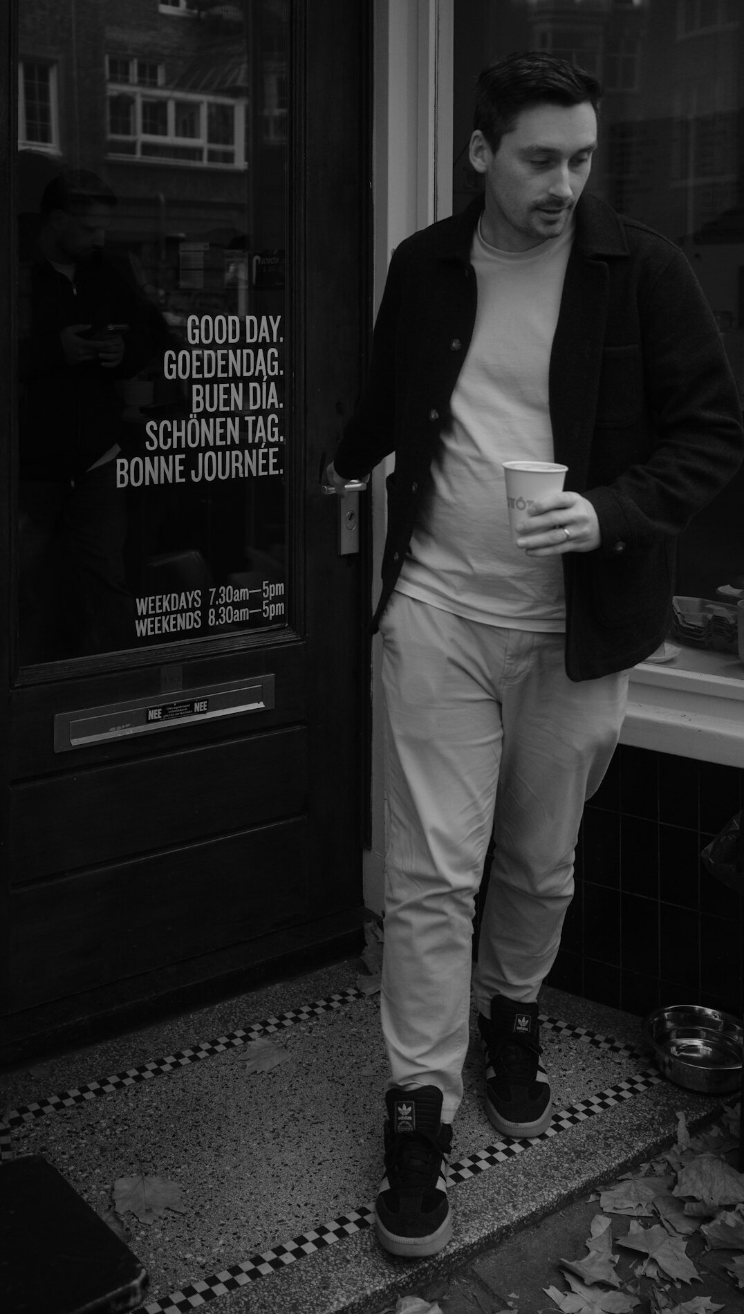 Portrait of a young European editorial writer with curly hair wearing a casual blazer