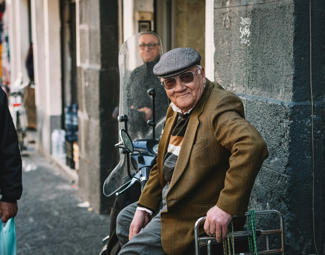 Portrait of a European advertising historian in his fifties wearing glasses and a tweed jacket